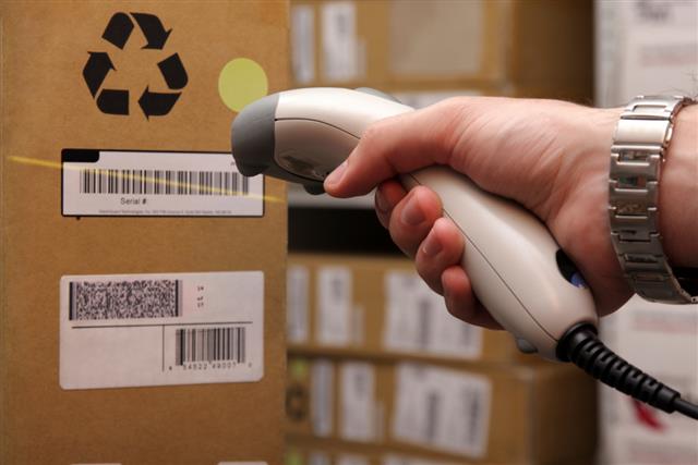 Man hand with Bar code scanner in operation