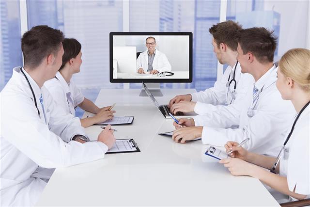 Doctors Having Video Conference Meeting In Hospital