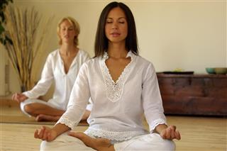 Two women meditating