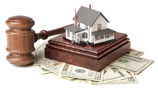 Gavel sound block and money with model house on white