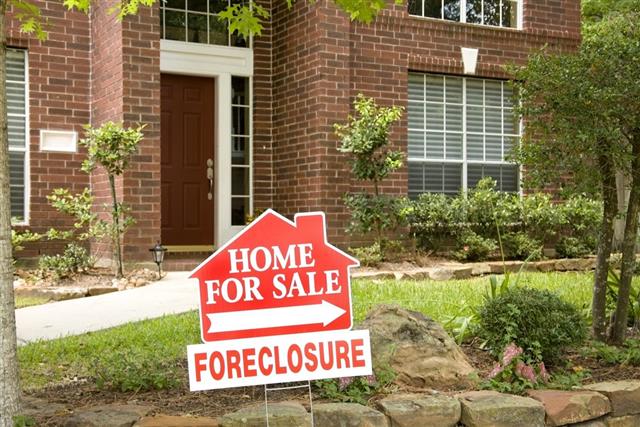 Real Estate Sign. Home for sale. Foreclosure. Red brick house.