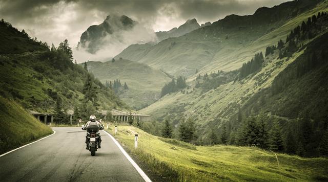 Motorcyclist on mountainous highway