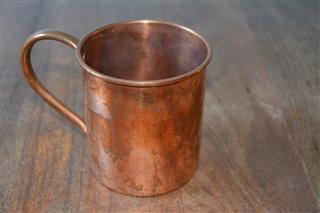Copper mug on a wood table