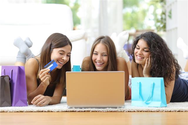Friends shopping online with credit card