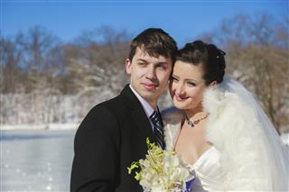 Bride and groom in winter park