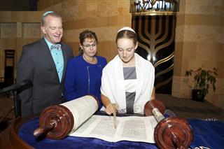 Bat Mitzvah Girl Reading the Torah with Her Parents