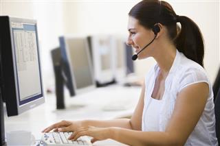 Woman wearing headset working in computer room