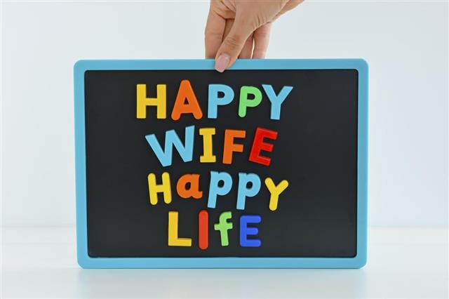 Happy wife happy life with colored letter blocks on blackboard