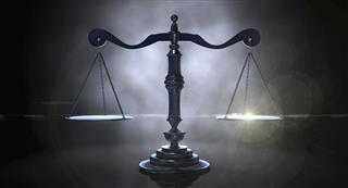 Scales of justice on dark background