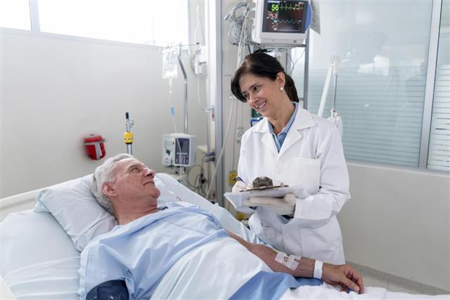 Doctor checking on a patient at the ICU