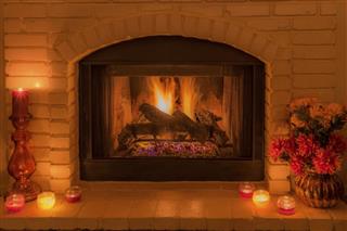 Cozy fireplace with flowers and candles