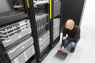 It consultant working with blade servers in datacenter