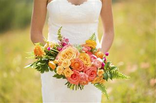 Wedding bouquet with Roses Ranunculus Snap Dragons Gomphrena and Echeveria