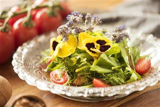 Healthy eating - salad with wild herbs and edible flowers