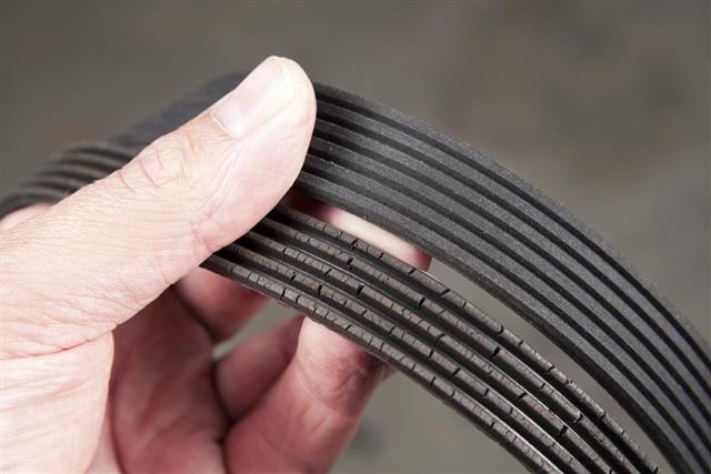 Mechanic Holding Old and New Serpentine Belts