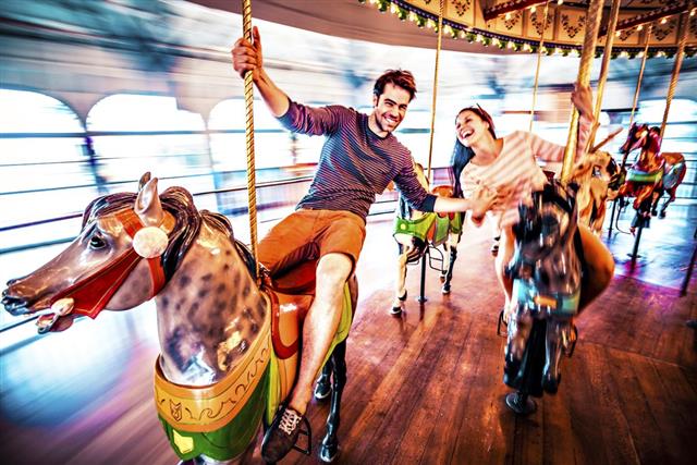 Couple riding merry-go-round in LA