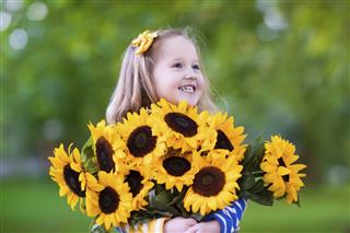 Little girl with sunflowers