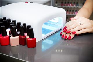 A woman at a nail salon drying her nails