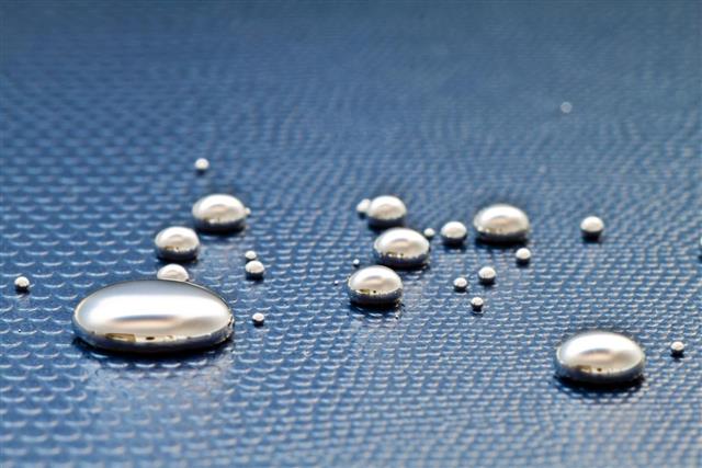 Droplets of mercury on a textural blue surface