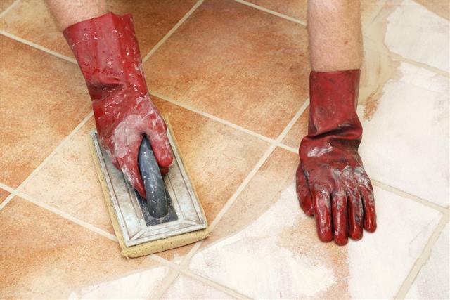 Removing excess grout from the tiles