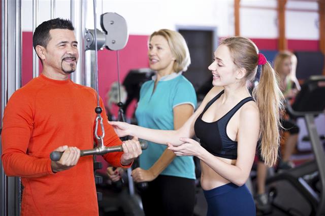 Adult people having strength training in gym