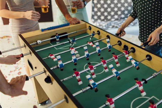 Young People Playing Foosball.
