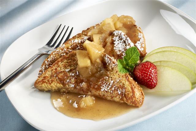 Whole wheat french toast with apples and a strawberry