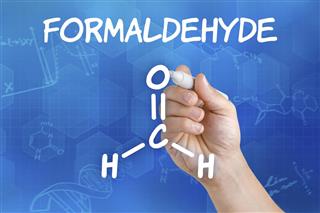 Hand with pen drawing the chemical formula of formaldehyde