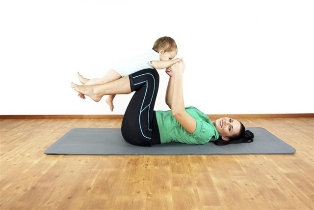Young teenage mother and daughter doing fitness