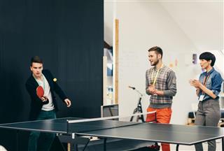 Young Business People Playing Table Tennis In Their Office