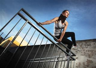 Woman jumping over fence obstacles