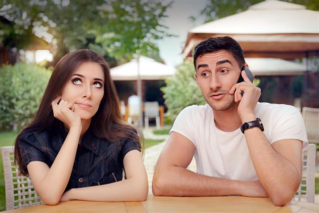 Girl Feeling Bored while her Boyfriend is on The Phone