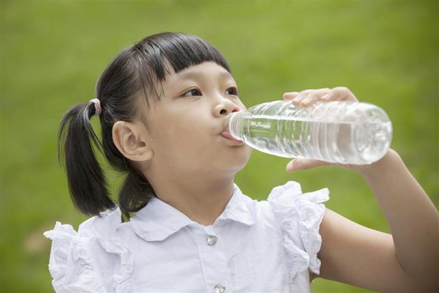 Asian girl drink with plastic bottle