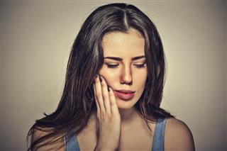 Woman with sensitive toothache about to cry from pain