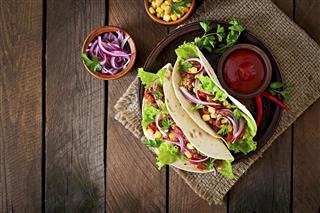 Mexican tacos with meat vegetables and red onion