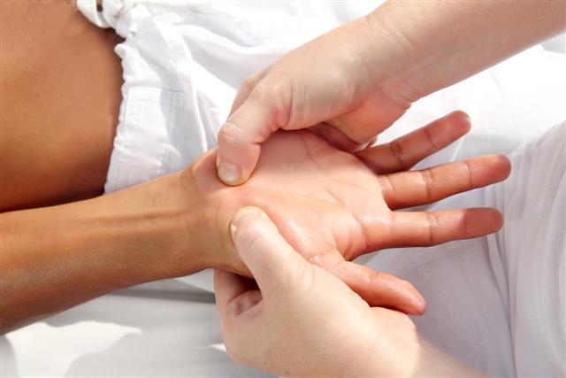 Reflexology massage uses pressure on hands for tuina therapy