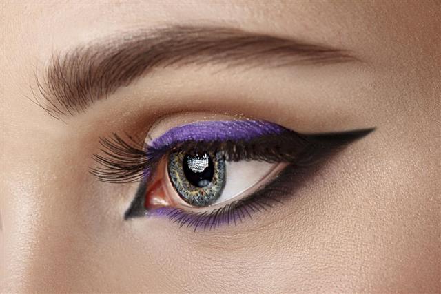 Closeup eye with makeup - arrow black and lilac
