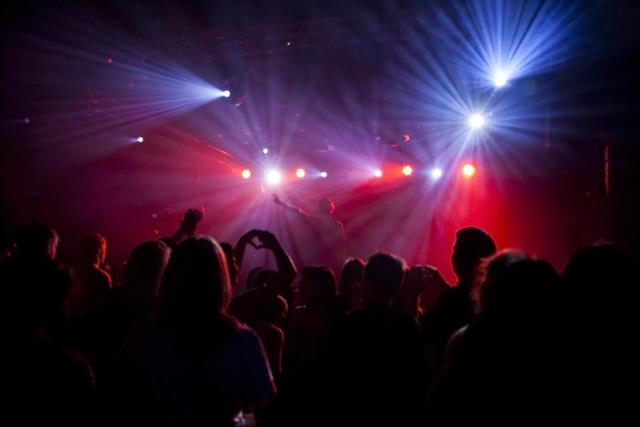 Nightclub lights and silhouette of a party crowd