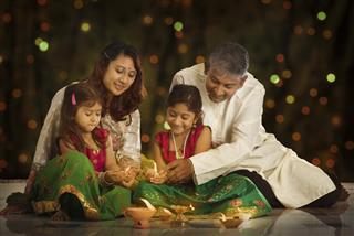 Indian family celebrating Diwali fesitval of lights