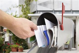 Man Taking Letter From Mailbox