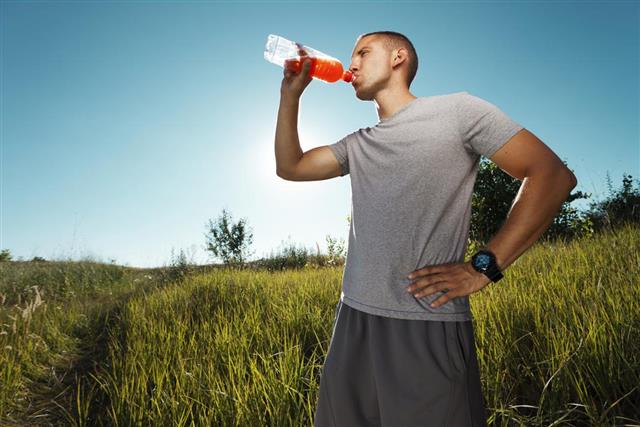Young man refreshing himself with power drink