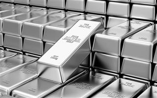 Stack of shiny silver bars inside a bank vault