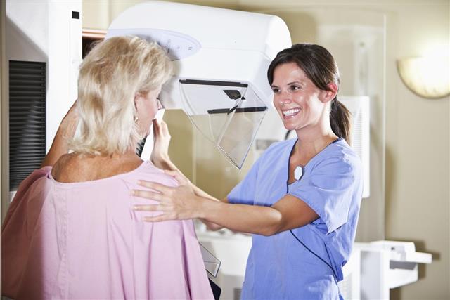 Nurse with patient getting mammogram