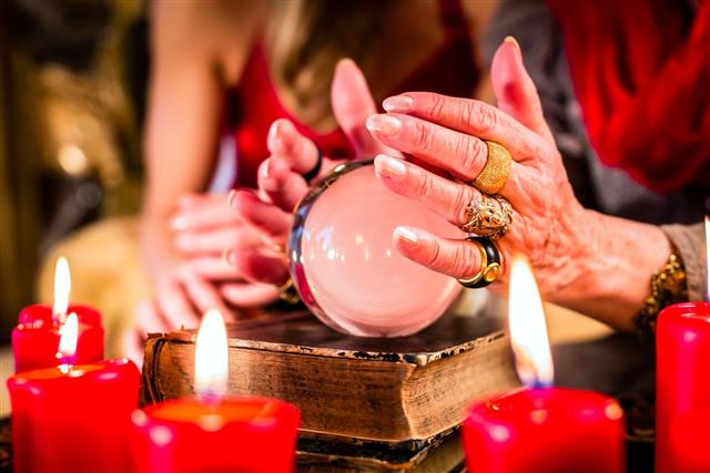 Fortuneteller during Seance with crystal ball