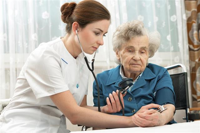 Measuring blood pressure of senior woman
