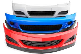 Red white and blue car bumpers stacked up