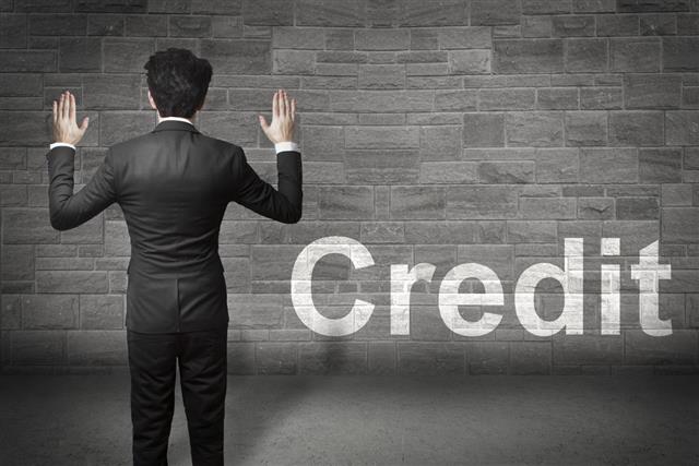 Businessman hands up wall credit