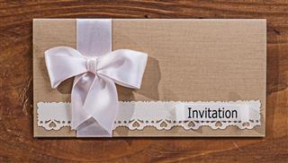 Wedding invitation envelope on old wooden board