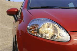 Close-up of the driving lights on a red compact car