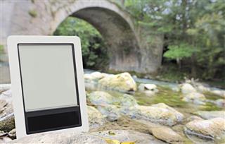 Digital tablet outdoors by river